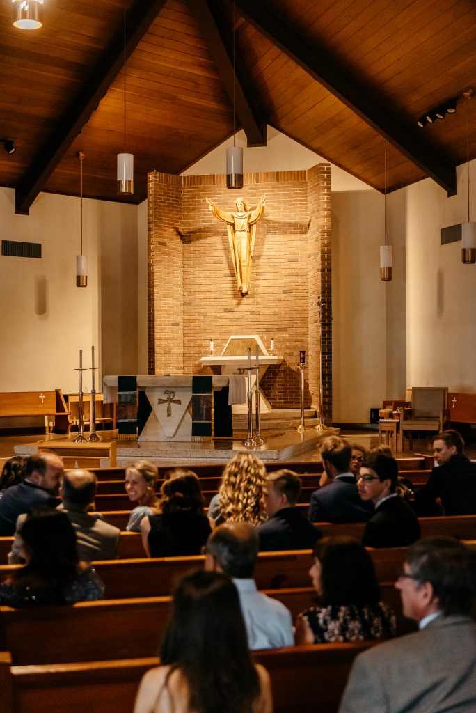 Family and friends gather excitedly as they wait for the bride and groom to arrive at their church wedding in once of the best places to get married in upstate new york